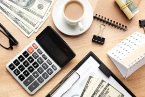 top-view-desk-arrangement-with-cash